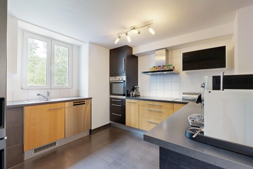 cuisine avec dark floor, hotte, plans de travail, dark countertops, et four
