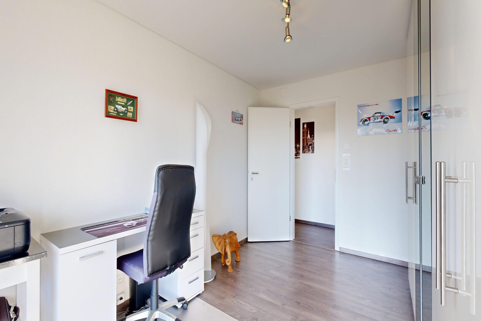 bureau avec espace bureau, cloison sèche, drywall, sol en finition bois, et wood finish floor