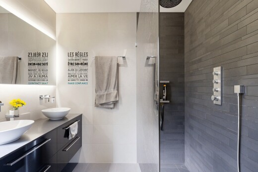 bathroom with double vanity and walk in shower