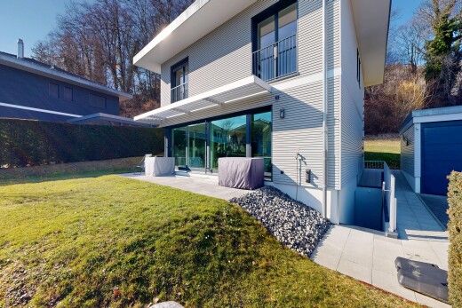 view of property featuring a yard, an outdoor structure, and a patio