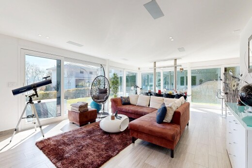 living room featuring light wood-style floors, plenty of natural light, and expansive windows