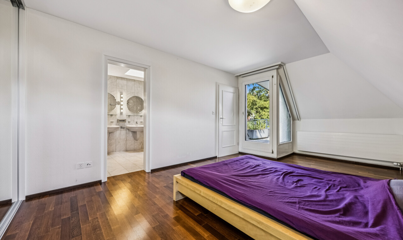 room / bedroom featuring dark wood-style flooring, access to outside, and ensuite bathroom