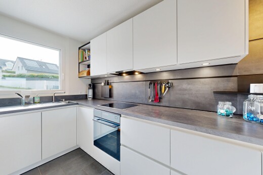 kitchen with white cabinetry, wall oven, light countertops, black electric stovetop, and modern cabinets