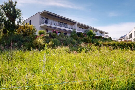 outdoor house with a balcony and stucco siding