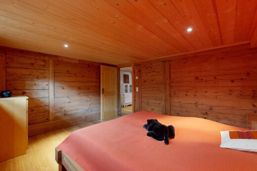 chambre avec wood finish floor, sol en finition bois, low ceiling, plafond bas, et wood wall