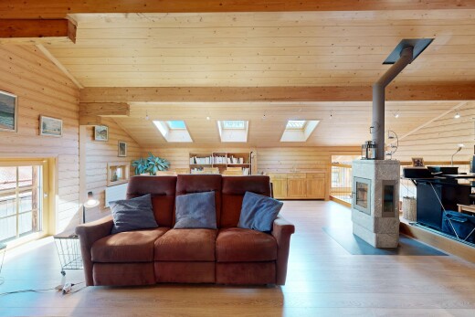 salon avec wood finish floor, sol en finition bois, vaulted ceiling, plafond voûté, et beamed ceiling