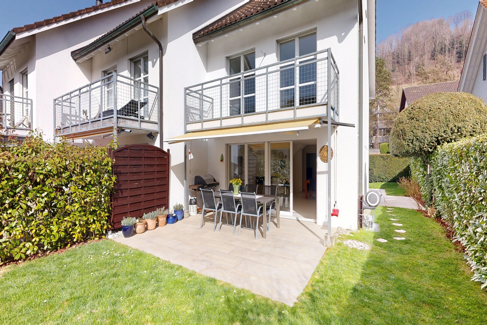 view of home with outdoor dining area, stucco siding, a patio, a tile roof, and a lawn