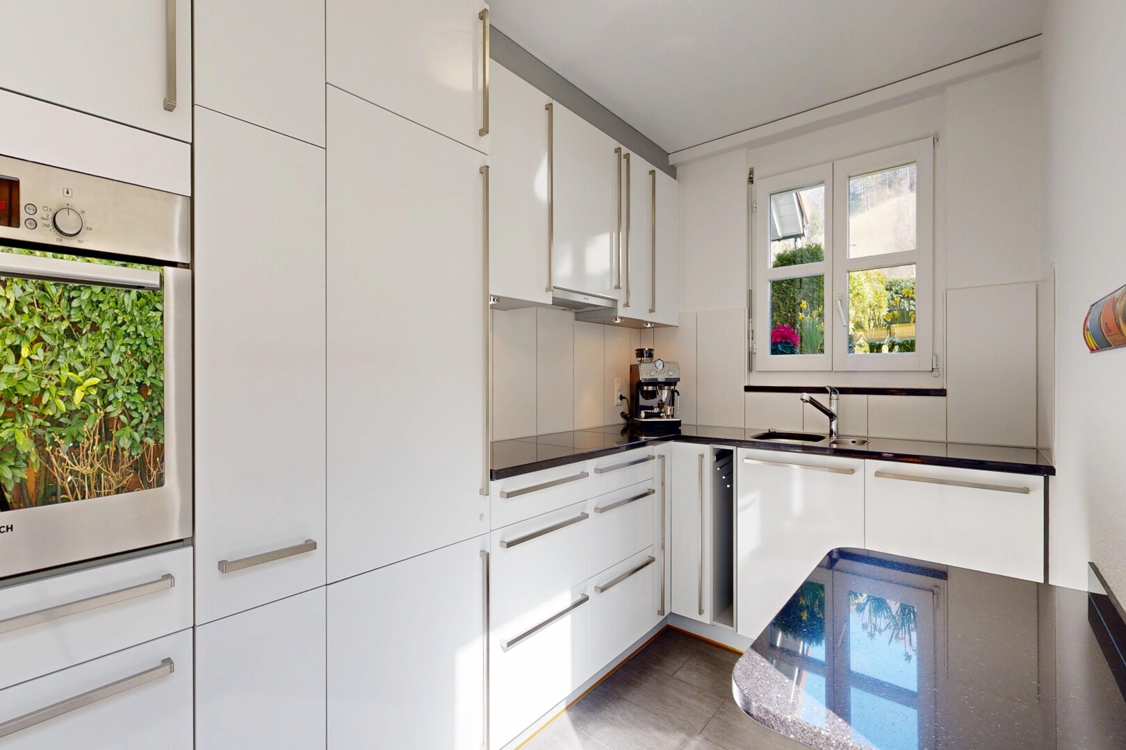 kitchen with white cabinetry, oven, and dark countertops