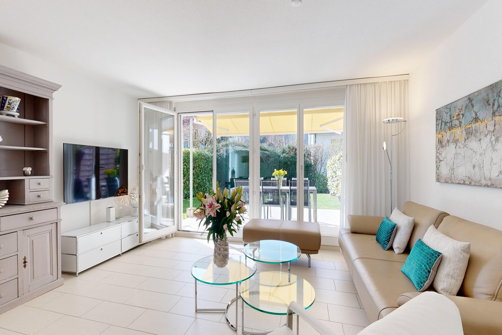 living room featuring expansive windows and light tile patterned flooring