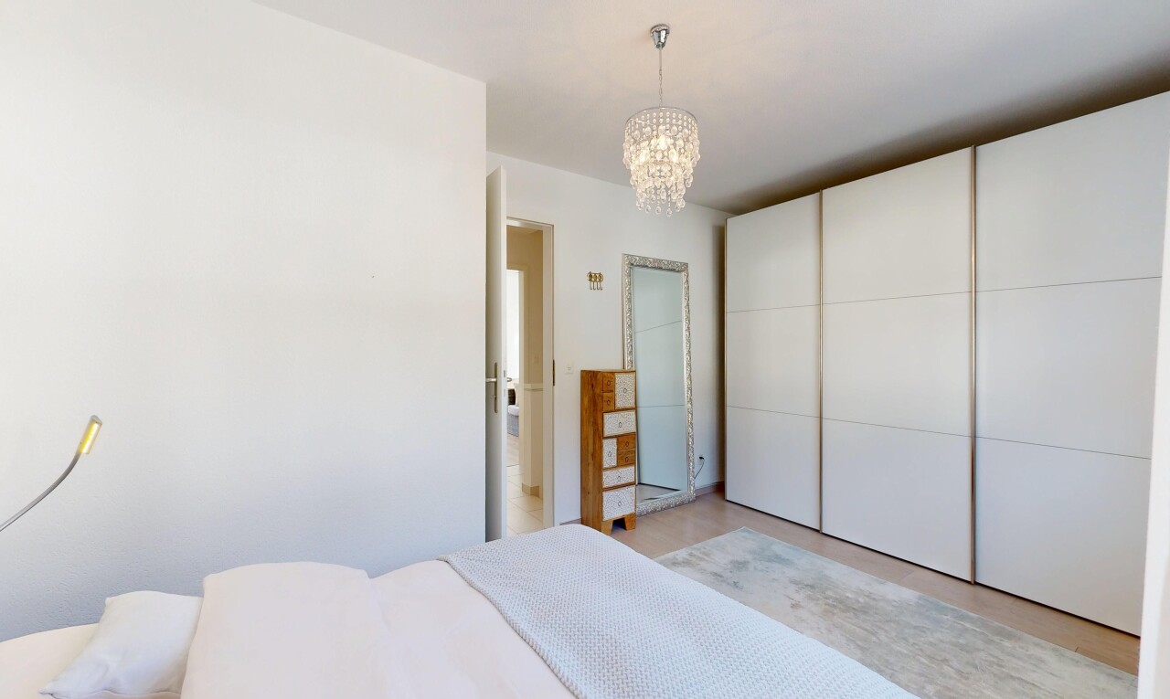 room / bedroom featuring a chandelier and a closet