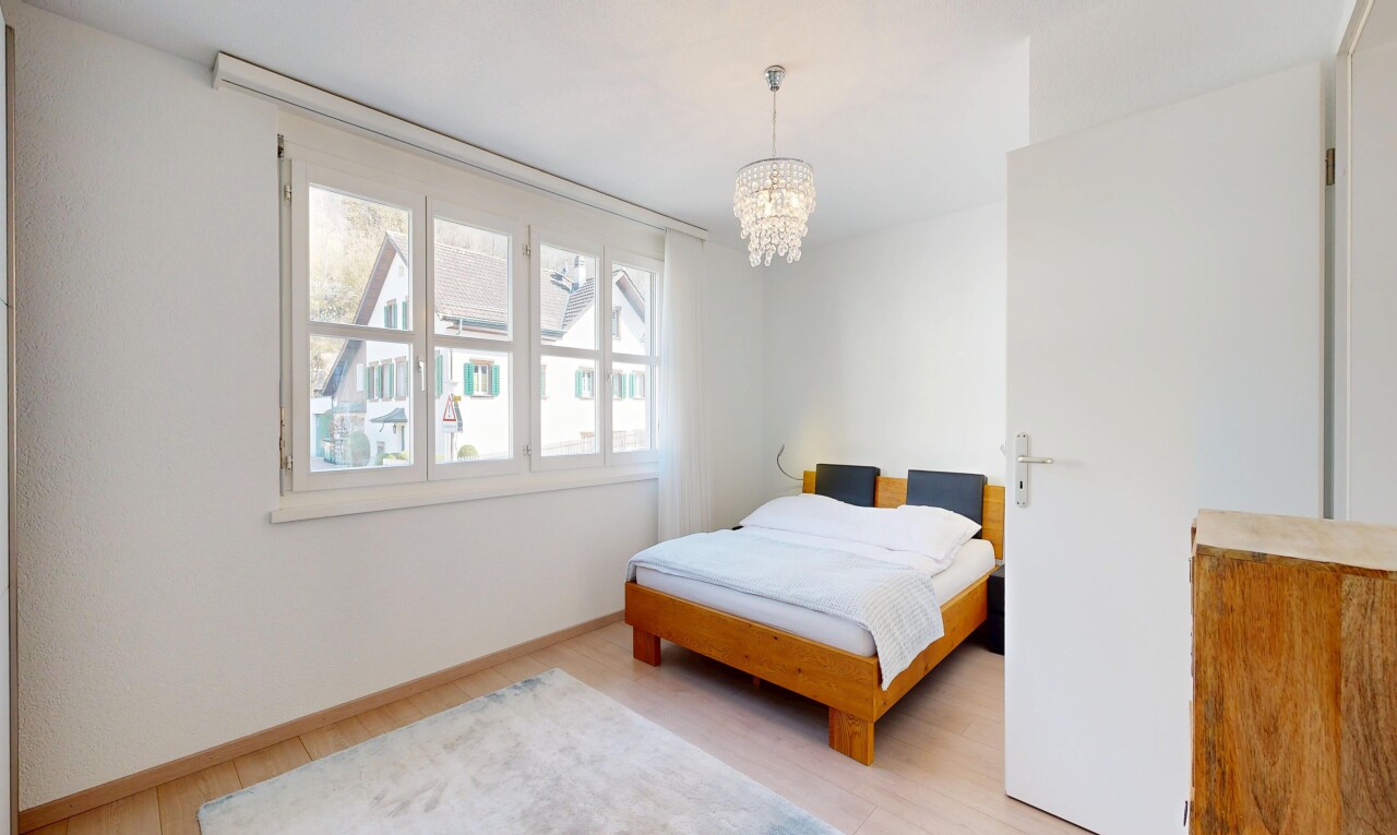 room / bedroom with light wood-style floors and hanging lights