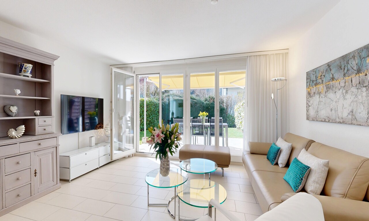 living room featuring expansive windows and light tile patterned flooring