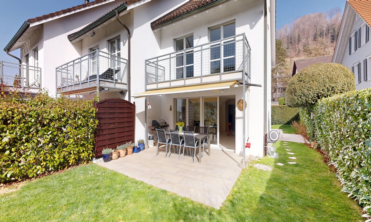 view of home with outdoor dining area, stucco siding, a patio, a tile roof, and a lawn