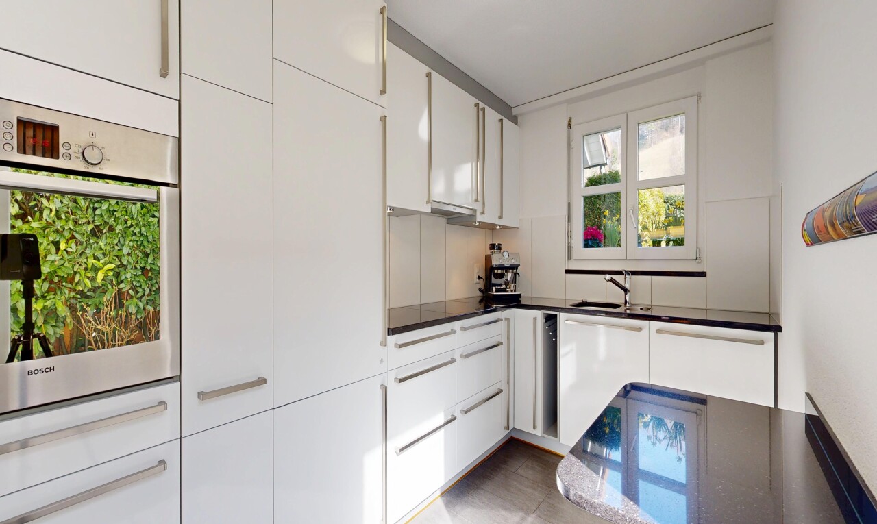 kitchen with white cabinetry, oven, and dark countertops