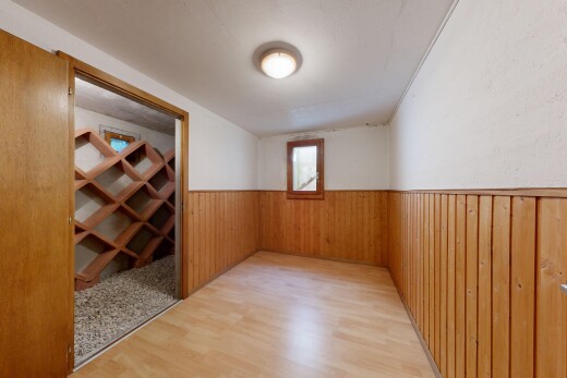 couloir avec inside property, sol en finition bois, wood finish floor, mur à lambris, et wainscot wall