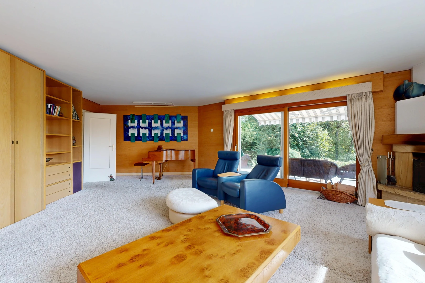 salon avec carpet, moquette, étagères intégrées, inside property, et accès à l'extérieur
