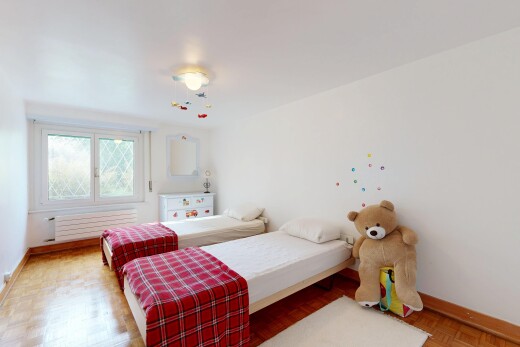 room with parquet flooring and radiator heating unit
