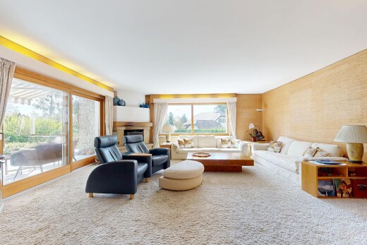 living room featuring carpet floors, a glass covered fireplace, and access to outside