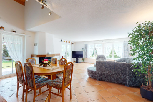 wohn- / esszimmer mit strukturierte decke, fernsehen, fliesenboden, und natürliches licht