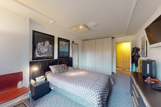 zimmer / schlafzimmer mit gipskartonwand, fernseher, und teppich