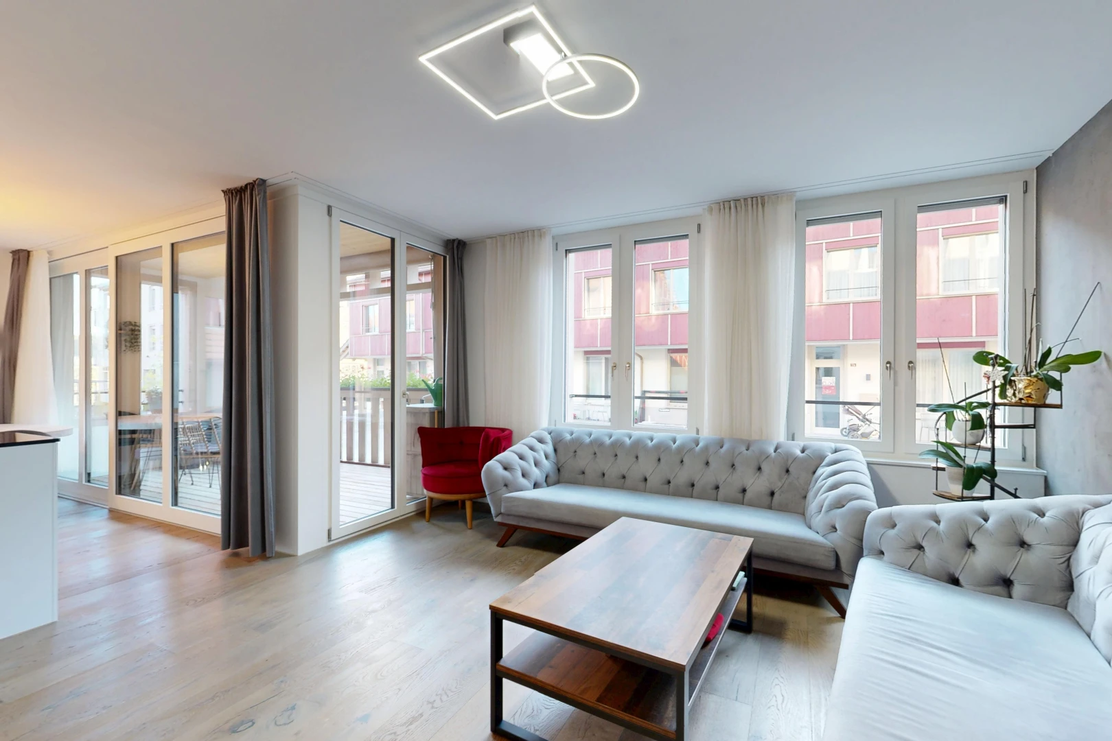 living area featuring access to outside, plenty of natural light, and light wood-type flooring