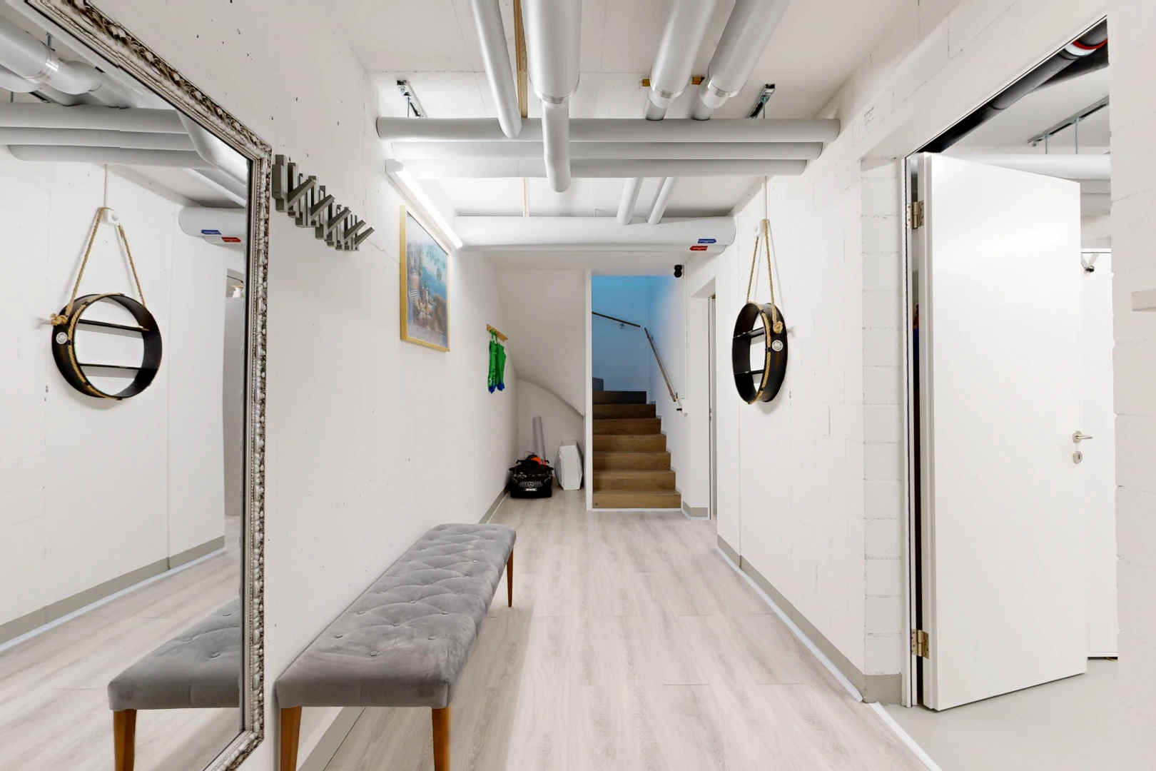 hallway featuring stairs and light wood-style flooring