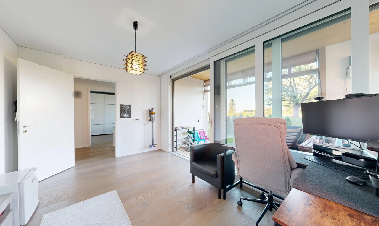 office with hanging light fixtures, access to exterior, and light wood-type flooring