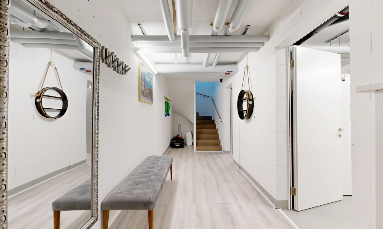 hallway featuring stairs and light wood-style flooring