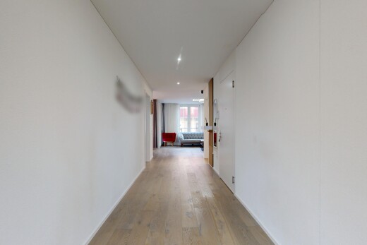 couloir avec light floor, sol en finition bois, wood finish floor, éclairage encastré, et inside property