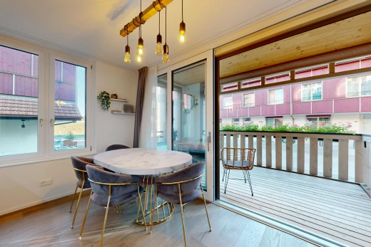 dining space featuring access to outside, light wood-style flooring, crown molding, and pendant lighting