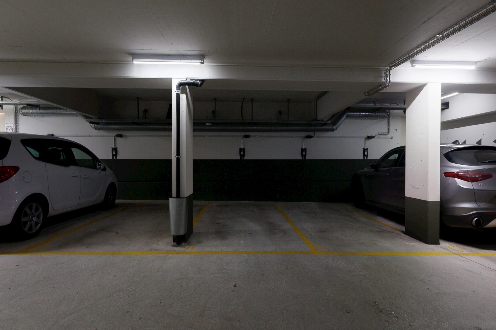 view of parking with a parking garage