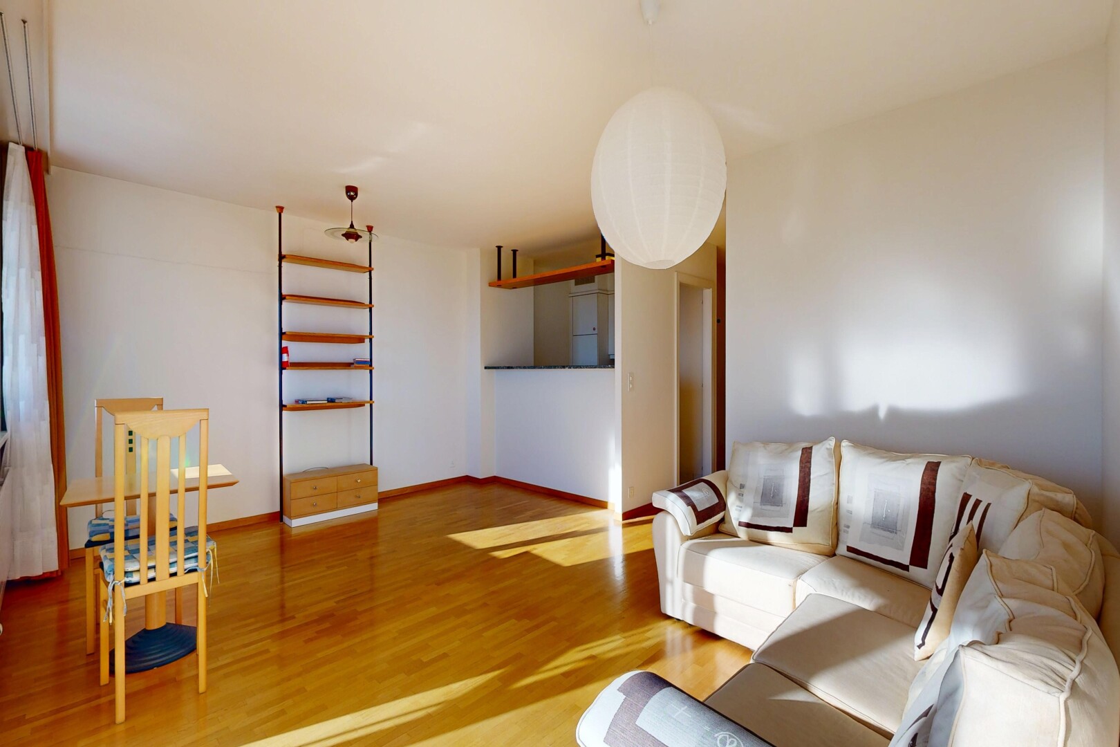 living area featuring light wood-style flooring and baseboards