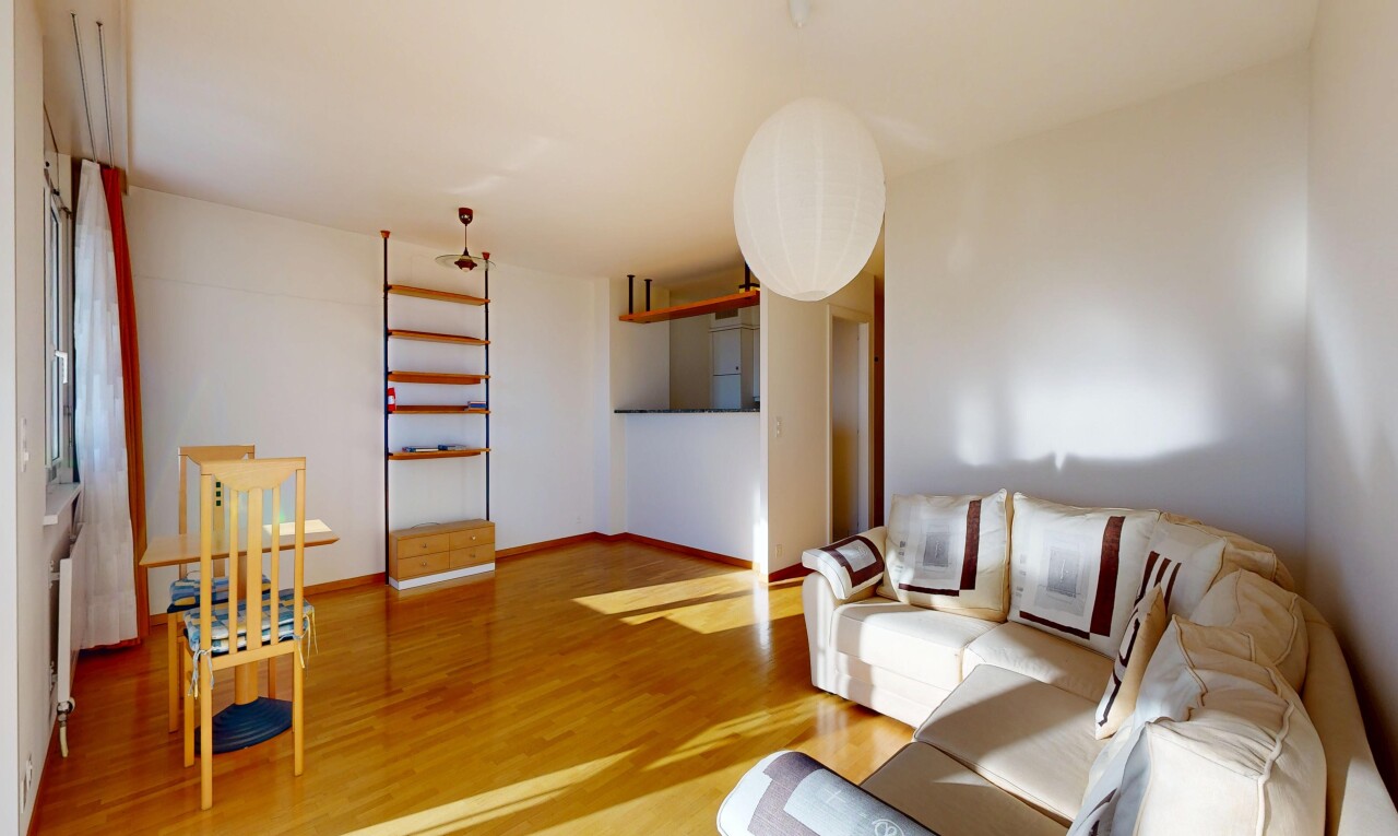 living area featuring light wood-style flooring and baseboards