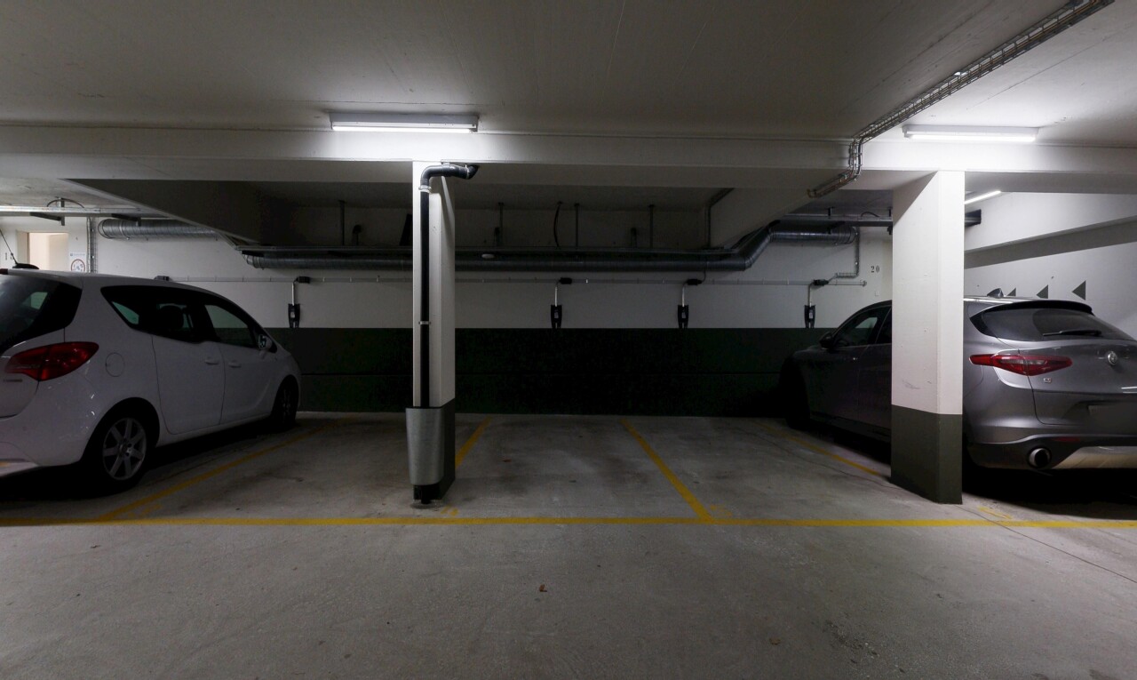 view of parking with a parking garage