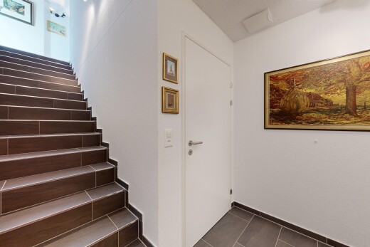 stairway featuring tile patterned flooring and baseboards