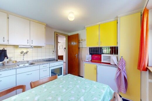 kitchen with a sink, backsplash, and white appliances