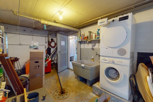 laundry area featuring laundry area, stacked washer and clothes dryer, and a sink