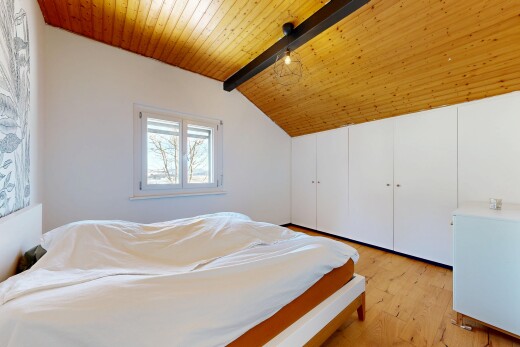 room / bedroom with light wood-style floors, wood ceiling, and a closet