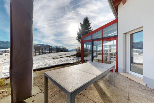 snow covered terrace featuring a patio area and a sunroom