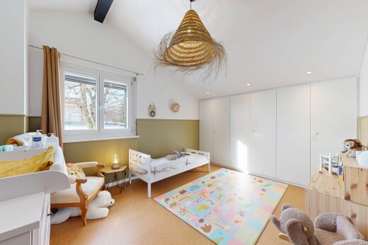 carpeted room featuring a chandelier
