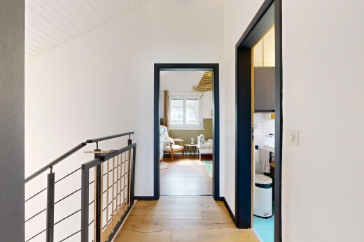 couloir avec sol en finition bois, wood finish floor, cloison sèche, drywall, et inside property