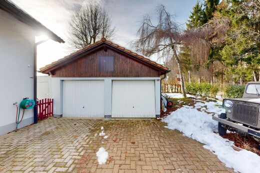 view of home with an outdoor structure and a garage