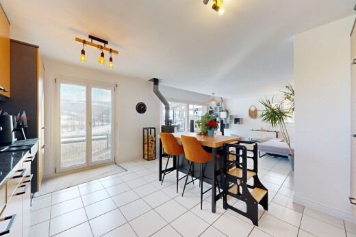kitchen featuring light tile patterned floors, rail lighting, open floor plan, and dark countertops