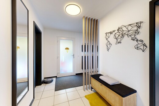 hall with light tile patterned floors