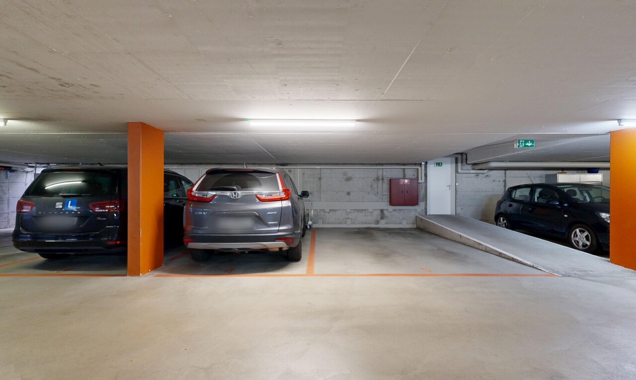 view of parking with a parking deck