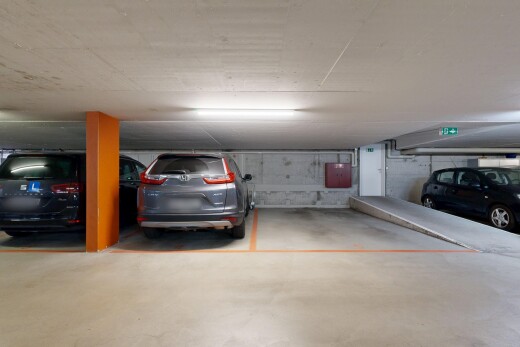 view of parking with a parking deck