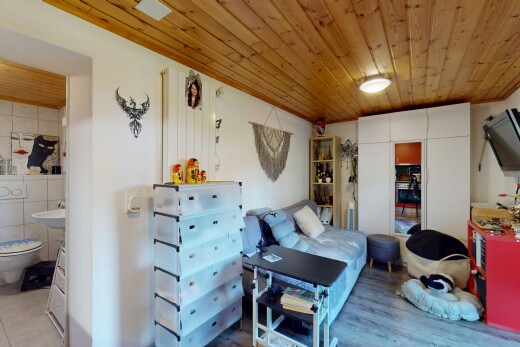 room featuring wooden ceiling, wood finished floors, and ensuite bath