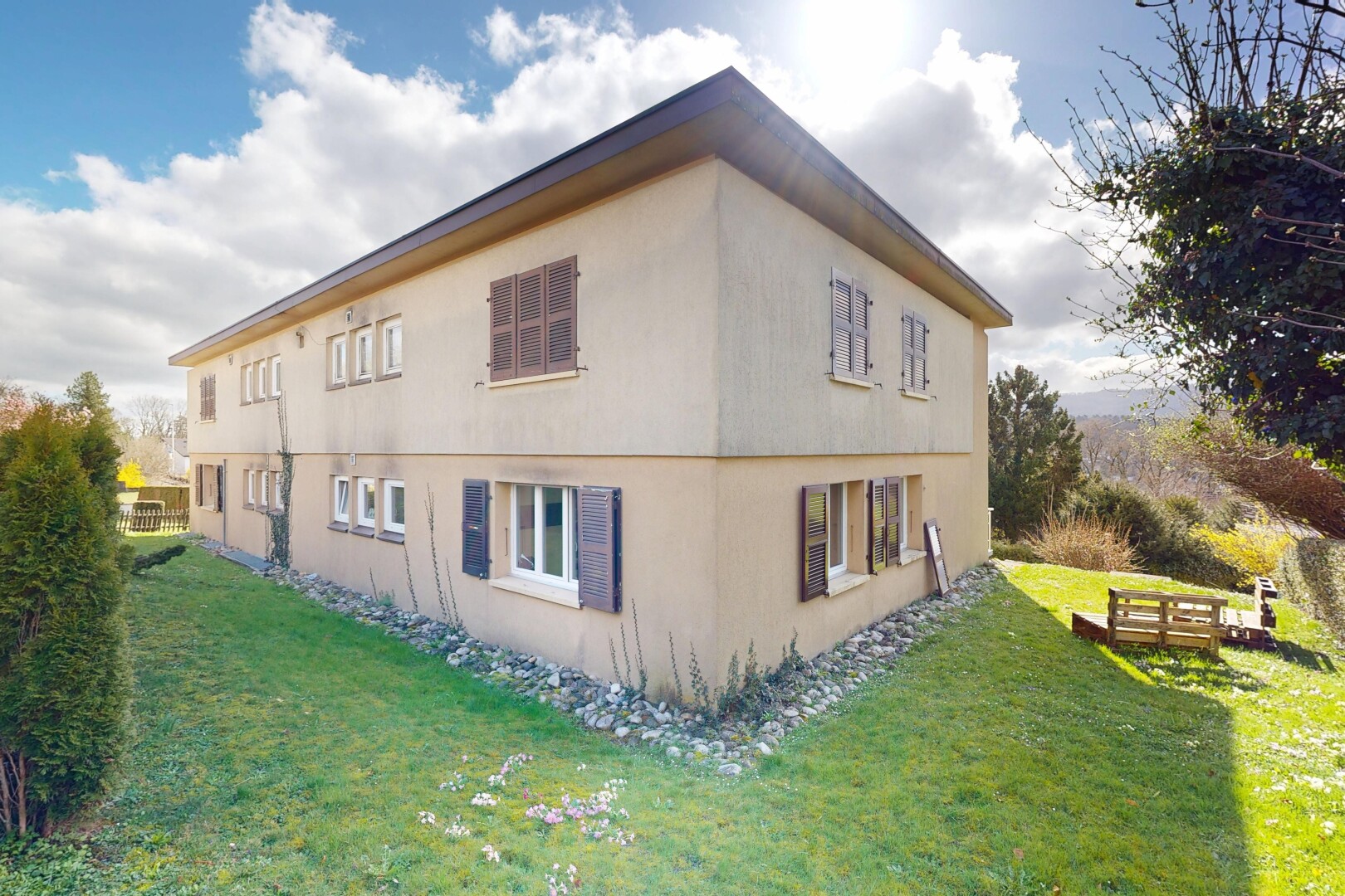 façade avec pelouse, property visible, bardage en stuc, et day time