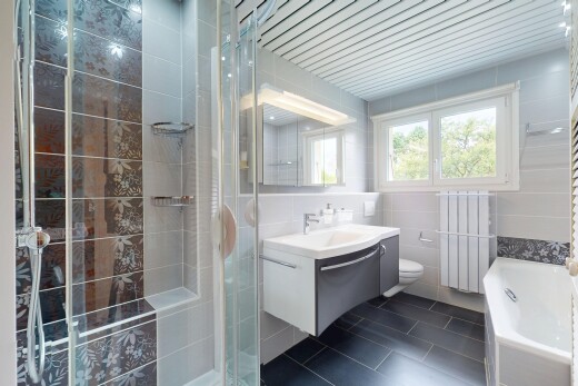 salle de bains avec tile wall, mur en carrelage, évier, lavabo (ou coiffeuse selon le contexte), et radiateur