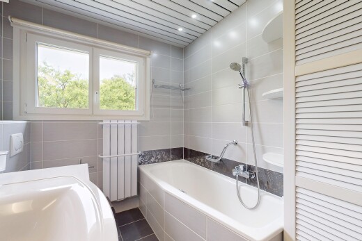 salle de bains avec radiateur, inside property, tile tub, natural light, et lumière naturelle